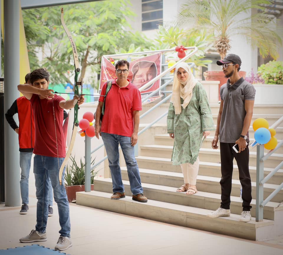 Visitor trying archery during an I-Bazaar activity